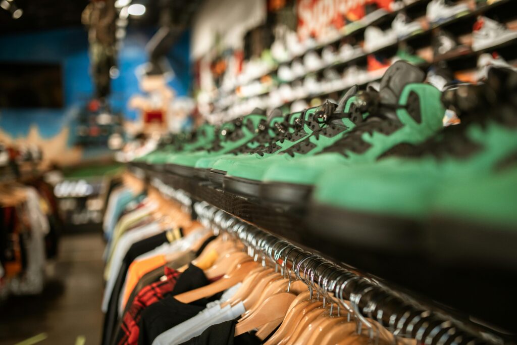 A row of trendy green sneakers on display in a stylish retail store.