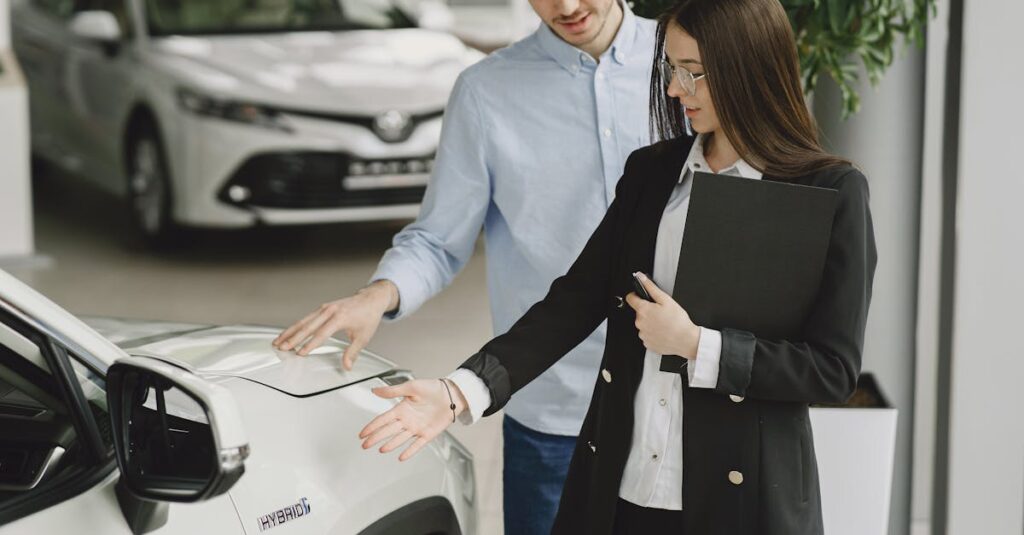A man and saleswoman discussing a hybrid vehicle's features in an indoor showroom.