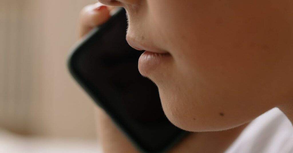 A close-up of someone talking on a smartphone, focusing on the lower face.