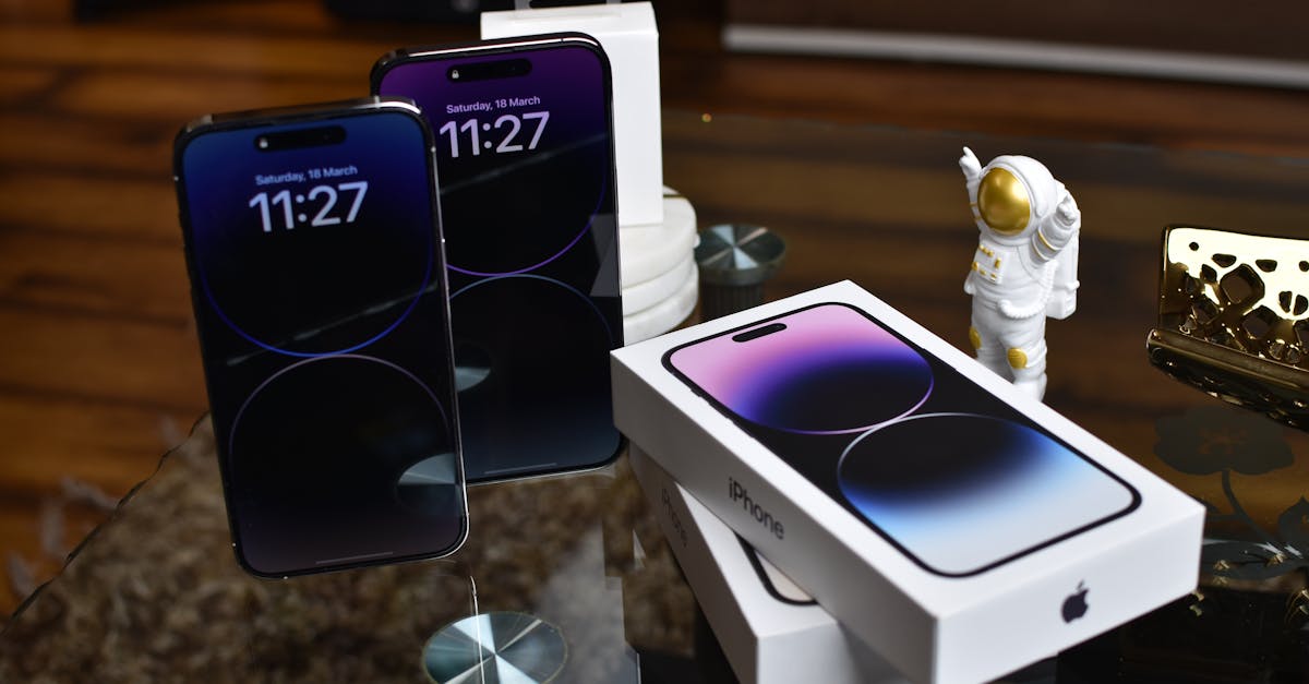 Close-up of Apple iPhone 14 Pro Max with astronaut figurine on a reflective surface.