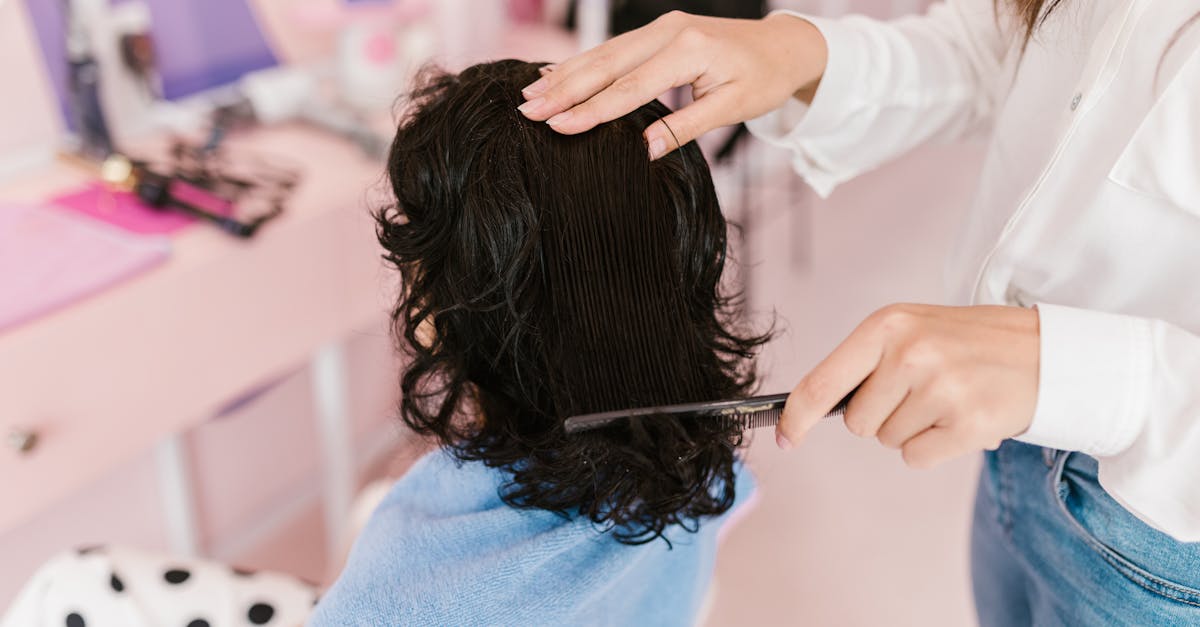 Close-up of a woman receiving hairstyling treatment in a contemporary salon.