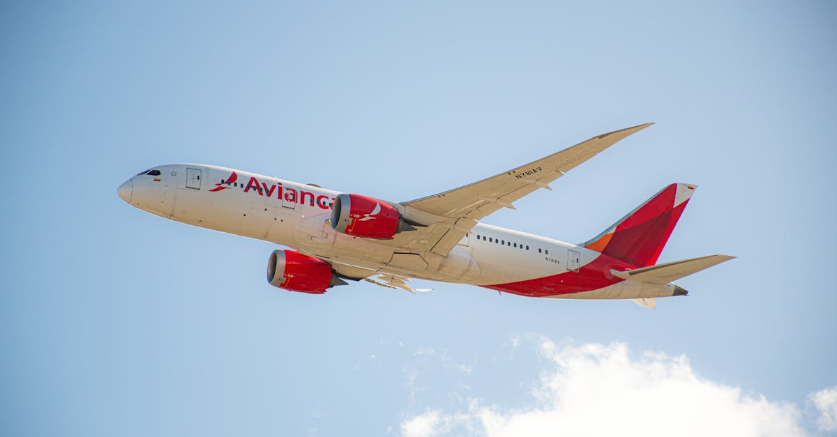 Avianca passenger jet flying under a clear blue sky, showcasing flight travel.