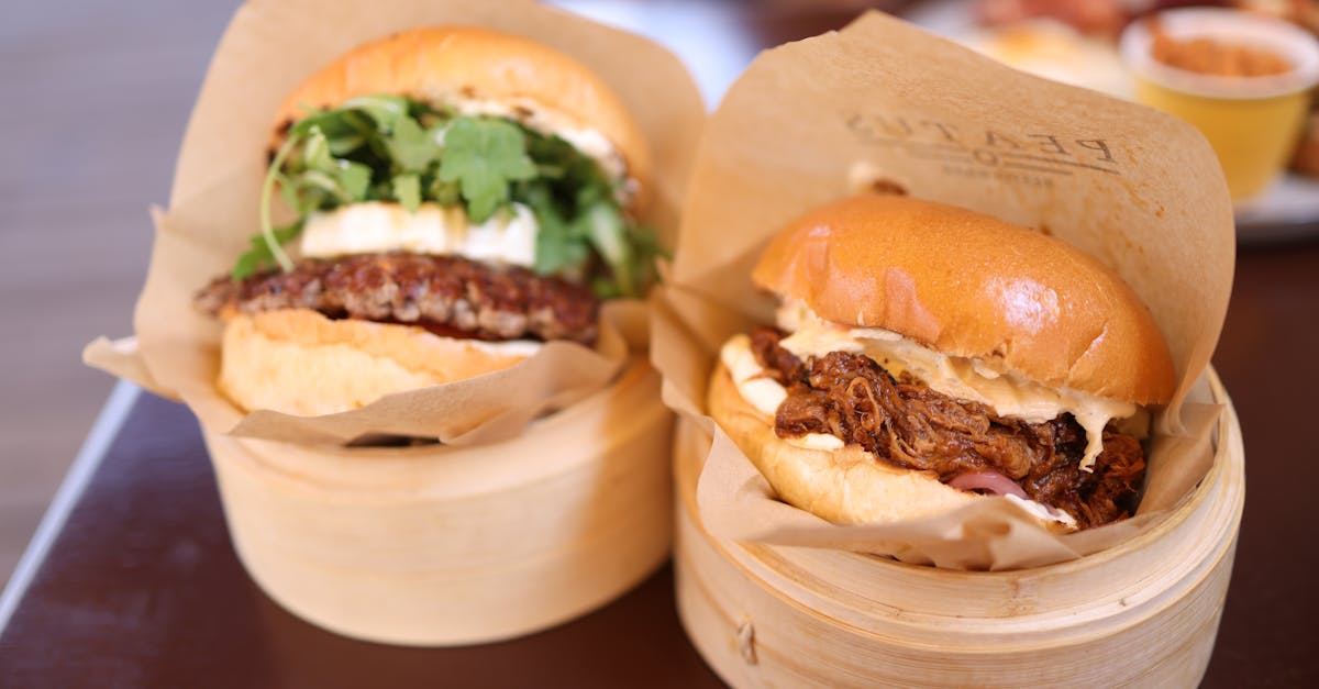 Close-up of gourmet beef burgers served in bamboo steamers, perfect for food photography.