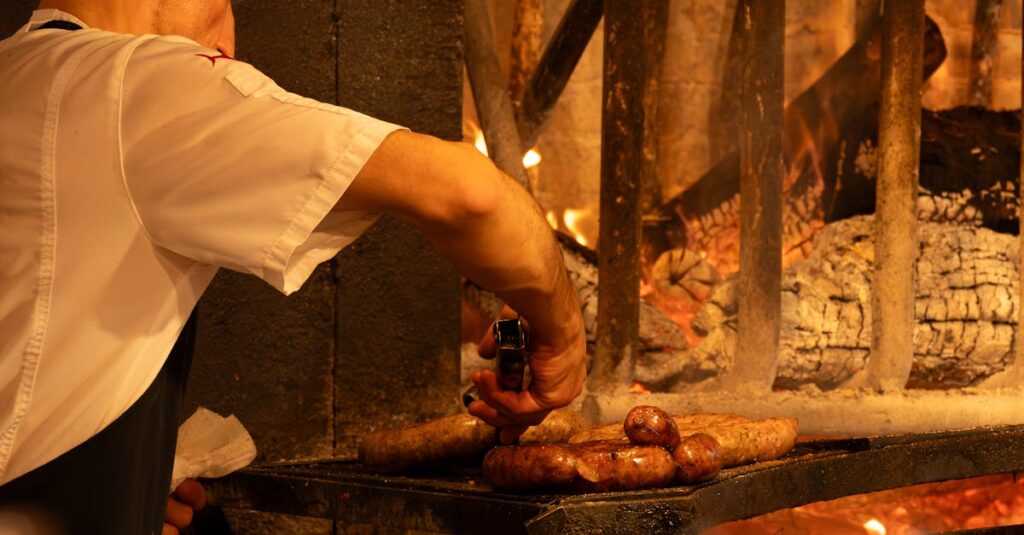 Chef grilling sausages on a traditional barbecue in Montevideo, Uruguay, showcasing local culinary culture.